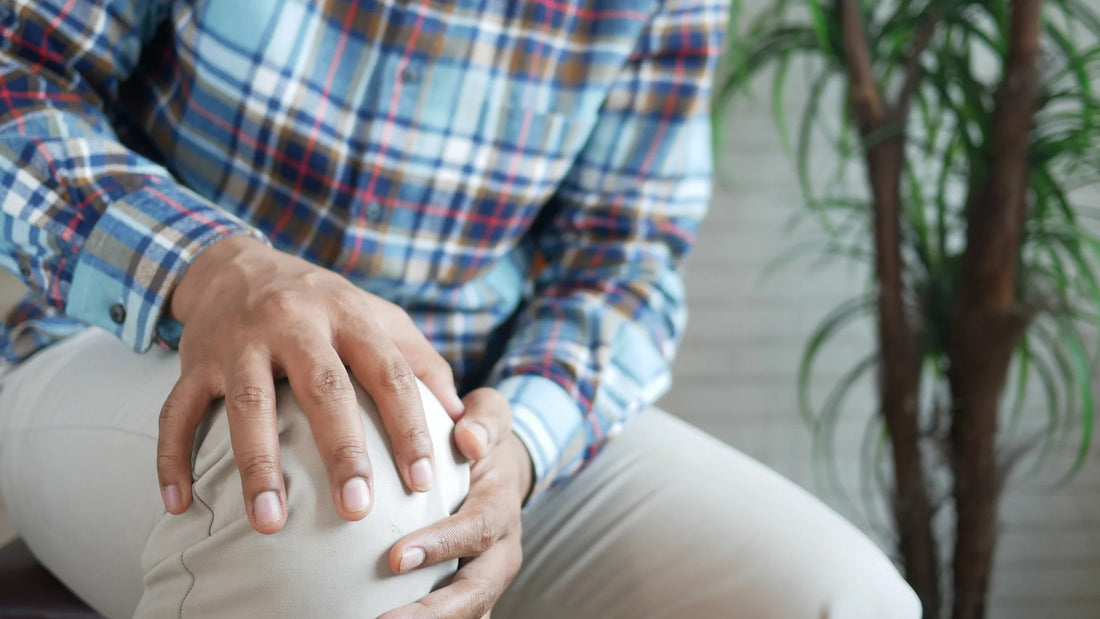 Person resting with knee discomfort after standing all day